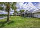 Expansive backyard boasts a screened pool and stunning waterfront views at 128 Torrington St, Port Charlotte, FL 33954
