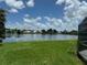 Lakeside view, showcasing a beautiful backyard and tranquil water at 128 Torrington St, Port Charlotte, FL 33954