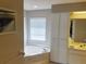 Bright bathroom featuring a large soaking tub, and large cabinets at 128 Torrington St, Port Charlotte, FL 33954