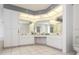 Bright bathroom featuring dual sinks, a vanity area, a toilet and great mirror lighting above the sinks at 128 Torrington St, Port Charlotte, FL 33954