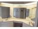 Bright bathroom featuring dual sinks, a vanity area and great mirror lighting above the sinks at 128 Torrington St, Port Charlotte, FL 33954