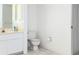 Bright bathroom featuring a toilet, a sink and neutral colors at 128 Torrington St, Port Charlotte, FL 33954
