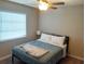 Comfortable bedroom featuring a ceiling fan and a window with natural light at 128 Torrington St, Port Charlotte, FL 33954