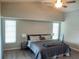 Bright bedroom featuring neutral walls, a ceiling fan, and two windows for plenty of natural light at 128 Torrington St, Port Charlotte, FL 33954