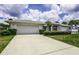 Charming single-story home with a two-car garage and well-maintained landscaping at 128 Torrington St, Port Charlotte, FL 33954