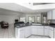 An open kitchen with a breakfast bar overlooks the living area and pool, offering seamless entertainment at 128 Torrington St, Port Charlotte, FL 33954