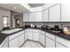 Galley kitchen offers ample counter space, white cabinets, and modern appliances, with an open layout at 128 Torrington St, Port Charlotte, FL 33954