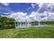 Breathtaking panoramic view of the lakefront property with lush foliage at 128 Torrington St, Port Charlotte, FL 33954