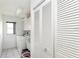 Bright laundry room features white washer and dryer with ample storage at 128 Torrington St, Port Charlotte, FL 33954