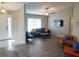 Spacious living room featuring modern furnishings, wood flooring, ceiling fan, and ample natural light at 128 Torrington St, Port Charlotte, FL 33954