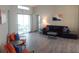 Open-concept living room features wood floors and access to an outdoor patio at 128 Torrington St, Port Charlotte, FL 33954