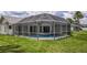 Screened-in pool with view of backyard is perfect for outdoor entertaining at 128 Torrington St, Port Charlotte, FL 33954