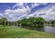 Relaxing view of the water with green grass in a peaceful location at 128 Torrington St, Port Charlotte, FL 33954