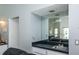 The convenience of a wet bar is demonstrated with its sink, mirrored backsplash and storage space at 128 Torrington St, Port Charlotte, FL 33954