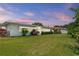 Expansive backyard featuring well-maintained lawn and views of the property's exterior at 14542 Anchorage Cir, Seminole, FL 33776