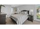 Comfortable bedroom with neutral tones, including a cozy bed with gray bedding, and ample natural light at 14542 Anchorage Cir, Seminole, FL 33776