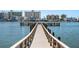 Picturesque view of a wooden dock extending into the water, buildings across the water at 14542 Anchorage Cir, Seminole, FL 33776