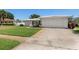 Charming home with well-manicured front yard, lush landscaping, and a long driveway at 14542 Anchorage Cir, Seminole, FL 33776