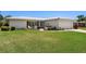 Charming single-story home with manicured front yard, lush landscaping, and tile roof at 14542 Anchorage Cir, Seminole, FL 33776