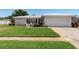 Charming single-story home with a well-maintained front lawn and neutral palette at 14542 Anchorage Cir, Seminole, FL 33776
