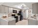 Modern kitchen with stainless steel appliances, grey cabinets and marble countertops at 14542 Anchorage Cir, Seminole, FL 33776