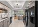 Modern kitchen area flowing into adjacent rooms, enhanced by a sleek fridge at 14542 Anchorage Cir, Seminole, FL 33776