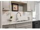 Close-up of updated kitchen with stainless steel faucet and marble countertops at 14542 Anchorage Cir, Seminole, FL 33776