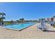 Community pool area with tables and lounge chairs next to the water for a relaxed lifestyle at 14542 Anchorage Cir, Seminole, FL 33776