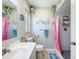 Bathroom featuring an updated vanity, decorative mirror, and a shower with a tile surround at 149 Sky Loch Dr E, Dunedin, FL 34698
