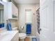 Bright bathroom featuring a tub with shower, medicine cabinet, and modern fixtures at 149 Sky Loch Dr E, Dunedin, FL 34698