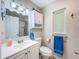 Bathroom with a white vanity, a window above the toilet, and a shower/tub combo at 149 Sky Loch Dr E, Dunedin, FL 34698
