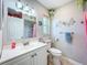 Bathroom featuring an updated vanity, decorative mirror, and a shower with a tile surround at 149 Sky Loch Dr E, Dunedin, FL 34698