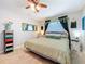 Bedroom featuring neutral carpet, ceiling fan, decorative mirror, and accent furniture at 149 Sky Loch Dr E, Dunedin, FL 34698