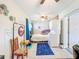 Cozy bedroom with a ceiling fan, laundry, and outdoor entrance at 149 Sky Loch Dr E, Dunedin, FL 34698