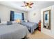 Bedroom featuring 2 beds, neutral carpet, and a large mirror at 149 Sky Loch Dr E, Dunedin, FL 34698