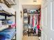 Walk-in closet providing ample storage with built-in shelving and hanging racks at 149 Sky Loch Dr E, Dunedin, FL 34698