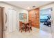 Dining area features a rustic wood accent wall with a view into the living area at 149 Sky Loch Dr E, Dunedin, FL 34698