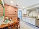 Charming dining area features a rustic wood accent wall and tile floors at 149 Sky Loch Dr E, Dunedin, FL 34698