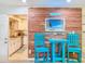 Cozy dining area showcases a decorative wood wall and stylish blue table set at 149 Sky Loch Dr E, Dunedin, FL 34698
