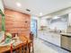 Charming dining area features a rustic wood accent wall and tile floors at 149 Sky Loch Dr E, Dunedin, FL 34698