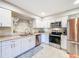 Bright, modern kitchen with stainless steel appliances and sleek white cabinetry at 149 Sky Loch Dr E, Dunedin, FL 34698