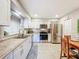 Bright kitchen features stainless steel appliances, white cabinets, and granite countertops at 149 Sky Loch Dr E, Dunedin, FL 34698