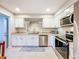 Spacious kitchen with stainless steel appliances and white cabinets at 149 Sky Loch Dr E, Dunedin, FL 34698