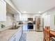 Bright kitchen features stainless steel appliances, white cabinets, and granite countertops at 149 Sky Loch Dr E, Dunedin, FL 34698