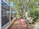 Enclosed patio with brick pavers and outdoor seating, perfect for relaxing in the shade at 149 Sky Loch Dr E, Dunedin, FL 34698