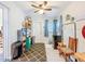Utility room featuring tile floor, ceiling fan, ample storage, and a back door to the exterior at 149 Sky Loch Dr E, Dunedin, FL 34698