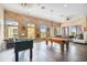 Large game room with pool table, foosball table, leather couches and windows, great for recreation at 1910 E Palm Ave # 10209, Tampa, FL 33605