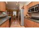 Well-lit kitchen featuring warm wood cabinets, hardwood floors and stainless steel appliances at 1910 E Palm Ave # 10209, Tampa, FL 33605