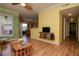 Well-lit living room featuring hardwood floors and a mounted flat screen TV at 1910 E Palm Ave # 10209, Tampa, FL 33605