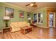 Inviting living room featuring hardwood floors, a cozy yellow couch, and large windows at 1910 E Palm Ave # 10209, Tampa, FL 33605